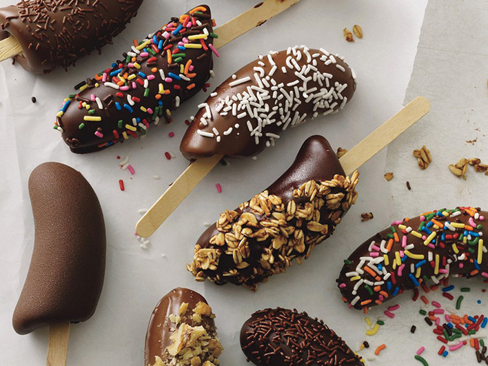 Batch of banana lollies decorated in many different ways